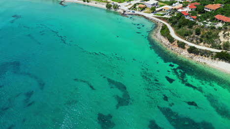 Sandy-beach-sea-water-in-popular-resort-town-Zante-Zakynthos-Greece,-aerial