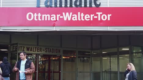 Unemployed-People-Exiting-Job-Fair-Expo-Hall-With-Application-Papers-in-Hand,-Germany