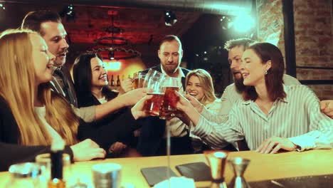 Young-cheerful-people,-men-and-women-gathering-in-pub-to-drink-delicious-beer,-have-good-time,-talk-and-relax.-Concept-of-leisure-time,-friendship,-fun-and-joy,-youth,-enjoyment