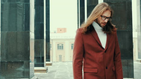 Attractive-bearded-hipster-man-in-red-fashion-coat