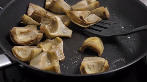 Cooking-artichoks-on-frying-pan.-Closeup