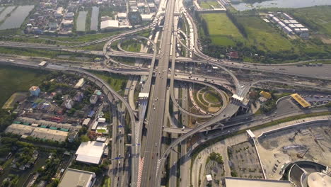 Aerial-View-of-Highway-Road-Interchange-with-Busy-Urban-Traffic-Speeding-on-Road