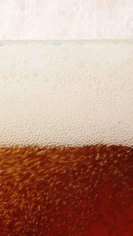 Close-up-of-beer-glass-with-lager-foamy-beer-pouring.-Bubbles-going-upwards.-Degustation.-Concept-of-beer-drink,-brewery,-taste,-bar,-degustation,-festival,-drink-texture.-Vertical-layout