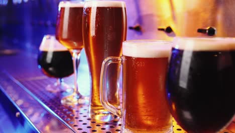 Close-up-image-of-beer-glasses-with-dark-and-lager-beer.-Selective-focus.-Cool,-chill-drink.-Refreshment.-Bar,-pub-atmosphere.-Concept-of-alcohol-drink,-party,-taste,-relaxation.