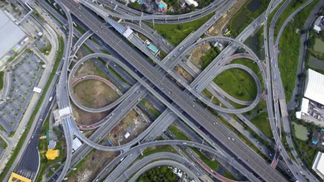 Aerial-View-of-Highway-Road-Interchange-with-Busy-Urban-Traffic-Speeding-on-Road