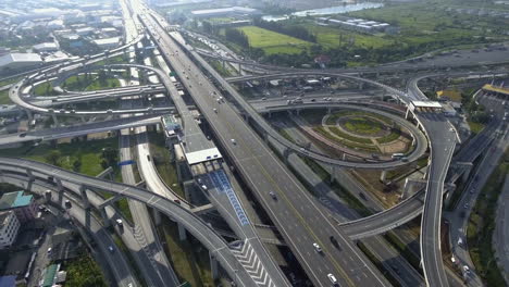 Aerial-View-of-Highway-Road-Interchange-with-Busy-Urban-Traffic-Speeding-on-Road