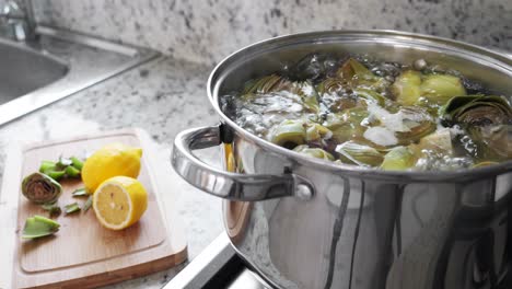 Boiling-and-cooking-artichokes-in-saucepan,-closeup