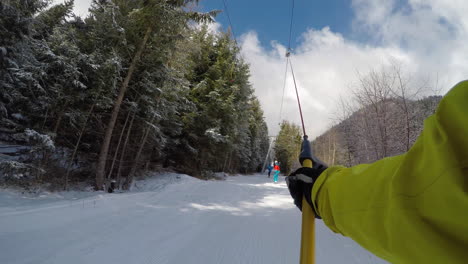 A-young-man-snowboarding-on-a-ski-track-among-pine-trees-at-a-ski-resort