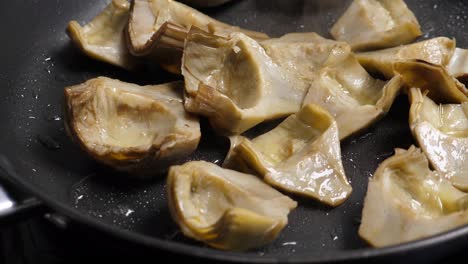 Cooking-artichoks-on-frying-pan.-Closeup