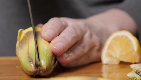 Woman-cut-artichoke.-Cooking-process.-Closeup