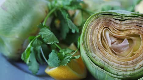 Cut-fresh-artichokes-on-plate,-rotating.-Closeup.-Nobody