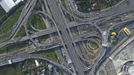 Aerial-View-of-Highway-Road-Interchange-with-Busy-Urban-Traffic-Speeding-on-Road