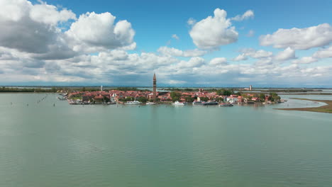 Beautiful-aerial-footage-of-Burano-Island-featuring-its-iconic-bell-tower,-colorful-houses,-and-tranquil-waterfront-in-Venice,-Italy