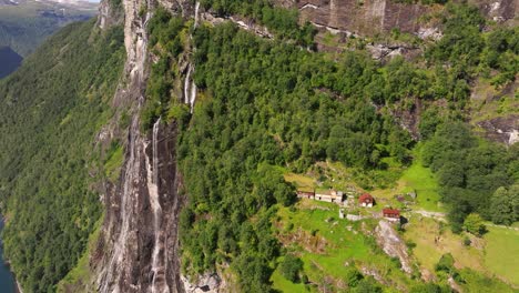 Drone-Orbits-Above-Mountain-Farm,-Seven-Sisters-Waterfall