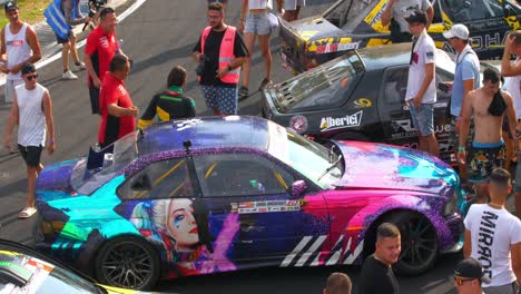 Female-pilot-getting-photo-taken-with-fans-during-the-car-exhibition