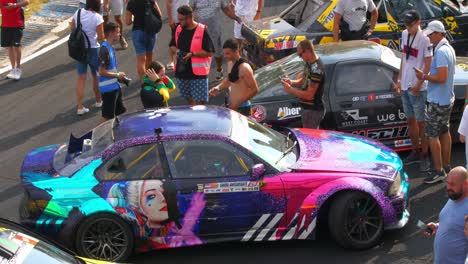 Female-pilot-taking-pictures-and-talking-to-fans-during-the-car-exhibition