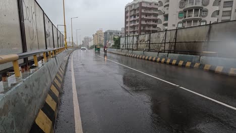 Traffic-of-many-vehicles-like-four-wheelers-is-visible-on-the-overbridged-even-in-continuous-rain