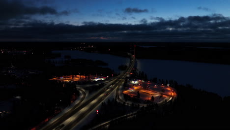 Aerial-view-of-Teboil-Tahtihovi-and-the-Tahtiniemi-Bridge,-winter-evening-in-Heinola,-Finland