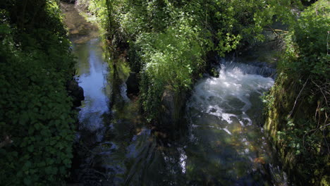 two-streams-converging-together-with-one-control-weir-at-Creswell-Crags,-Worksop