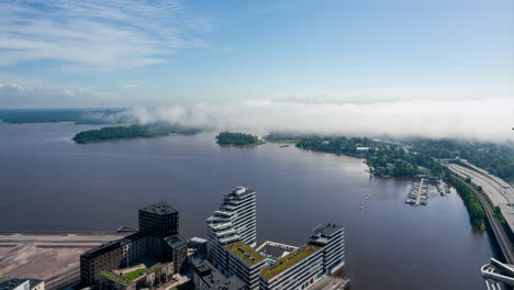 Timelapse-of-fog-moving-over-sea-and-East-Helsinki,-sunny,-summer-day-in-Finland