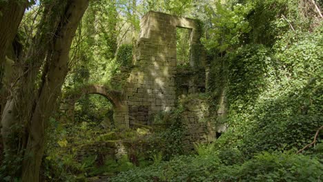 wide-shot-of-the-remains-upper-bleaching-mill-at-Lumsdale-waterfalls,-Matlock