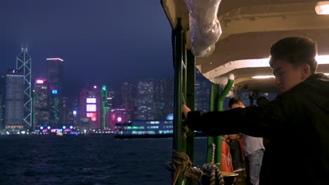 Visitors-take-a-nighttime-ride-on-the-Star-Ferry,-enjoying-views-of-the-Hong-Kong-skyline