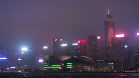 View-of-Victoria-Harbour-at-night,-featuring-the-dynamic-Hong-Kong-skyline-and-the-Hong-Kong-Convention-and-Exhibition-Centre-