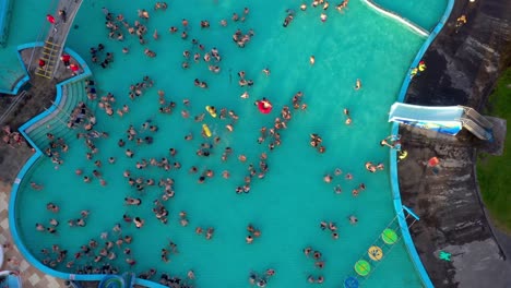 Aerial-of-crowd-of-people-bathing-in-outdoor-public-swimming-pool-in-summer