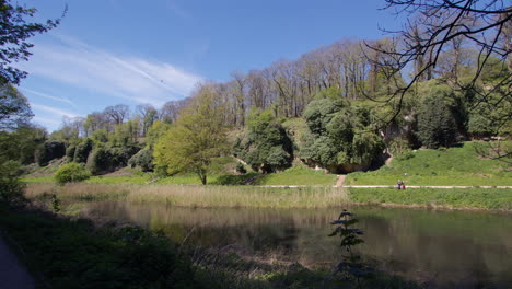 extra-wide-shot-looking-north-across-the-lake-pond-at-Creswell-Crags,-Worksop