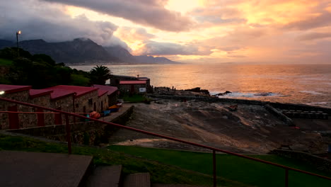 Hermnaus-Old-Harbour-outdoor-museum-buildings-and-fishing-boats,-vivid-sunrise