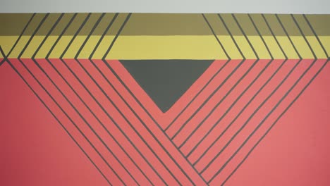 Mural-painting-featuring-Afro-Indigenous-art-in-red,-yellow,-and-black-strokes