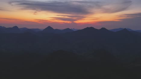 Aerial-view-revealing-a-magnificent-sunrise-over-the-mountainous-landscape-of-Arraial-do-Sana,-Rio-de-Janeiro,-Brazil