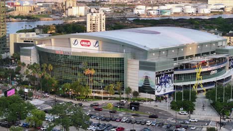 Amalie-Arena-in-Tampa,-home-of-the-Lightning,-with-parking-lots-and-surrounding-buildings-visible