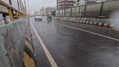 Water-is-being-blown-both-ways-by-vehicles-on-fridge-in-continuous-rain