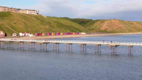 Aerial-drone-view-of-Saltburn-by-the-sea,-Saltburn-pier-and-ocean-in-Cleveland,-North-Yorkshire-in-summer,-early-morning