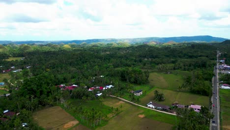 Aerial-Pan-Up-Above-A-Street-In-Urban-Manuel-Philippines-On-Cloudy-Day