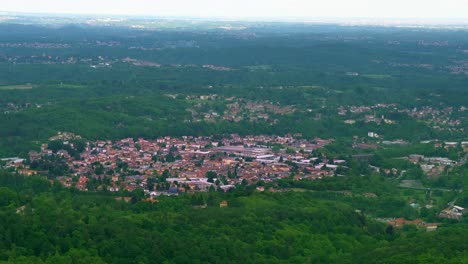 Small-township-of-Italy-surrounded-with-green-landscape,-aerial-panoramic-view