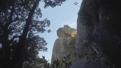 Monumental-rocks-naturally-positioned-in-Arraial-do-Sana,-Rio-de-Janeiro,-Brazil,-with-tree-silhouettes-around,-revealing-the-rock-monument