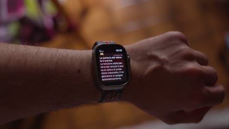 Wrist-turning-to-view-an-app-notification-from-a-dash-cam-on-a-smartwatch