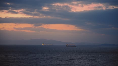 Commercial-Ships-Sailing-At-Sunset-Near-Saikazaki,-Wakayama,-Japan