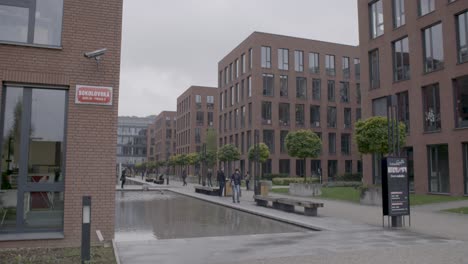 Modern-brick-office-buildings-line-a-quiet-street-in-Prague-on-an-overcast-day