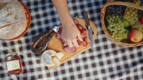 Traditional-picnic-with-portuguese-sausages,-cheese,-honey,-grapes,-basket,-towel,-bread