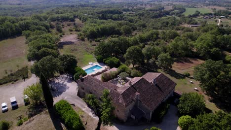 Aerial-revealing-shot-of-a-wealthy-villa-and-pool-in-the-countryside-of-France