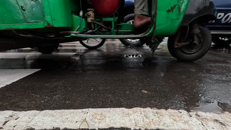 A-many-vehicles’-wheels-passing-out-side-of-camera