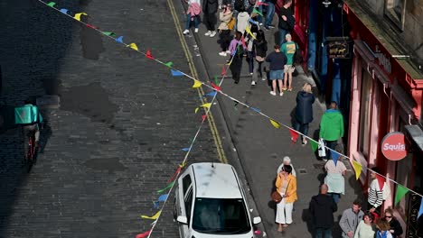 Colourful-flags-in-Victoria-Street,-Edinburgh,-Scotland