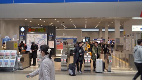 A-steady-gimbal-shot-moving-from-right-to-left,-capturing-the-walk-through-the-JR-ticket-gate-area-at-Kansai-Airport,-Osaka