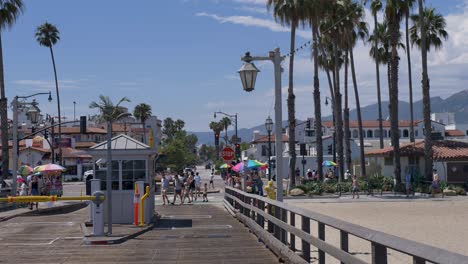 Slow-motion-view-of-Santa-Barbara-boardwalk-coastline-with-main-town-roads-street-with-scenic-foreshore-beach-buildings-and-palm-trees-travel-tourism-holidays-USA-America-California