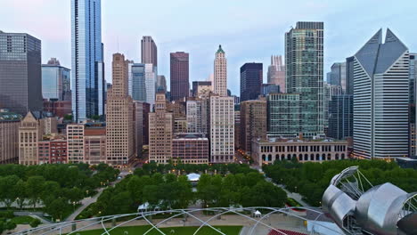 Aerial-tilt-shot-toward-the-Bean,-Cloud-Gate,-summer-morning-in-Chicago,-USA