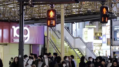 Shibuya-109-at-night-with-people-wearing-face-masks