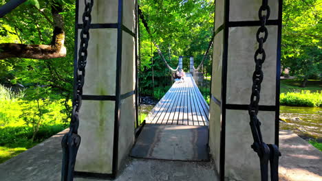 Serene-suspension-bridge-at-Keila-Joa,-surrounded-by-greenery,-tourist-attraction